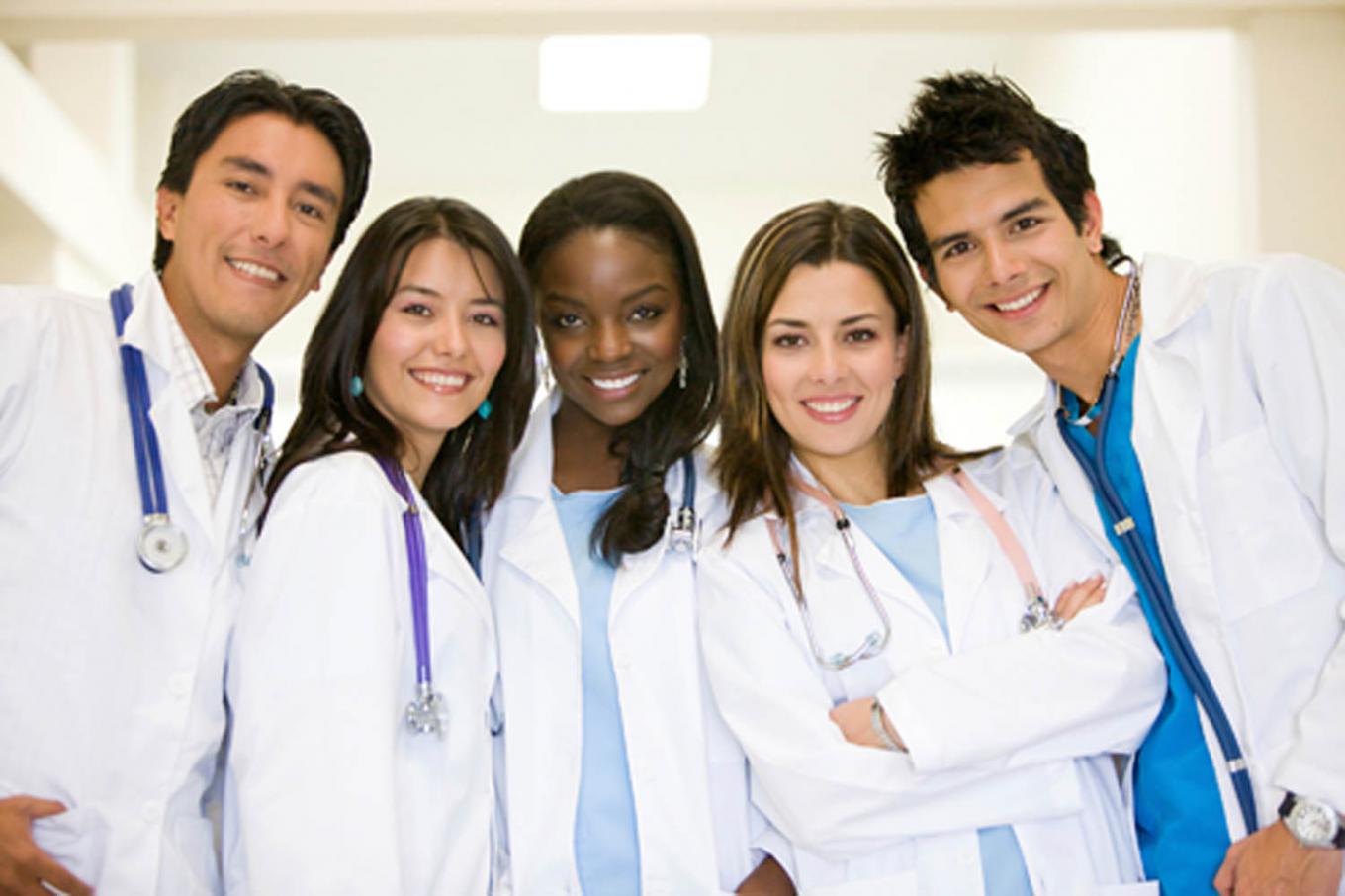 Smiling students in white lab coats